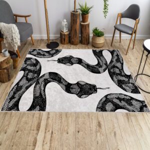 Black White Snake rug in front of a sofa, featuring a bold black and white snake pattern