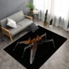 X-Wing Starfighter area rug in front of a sofa, featuring the iconic Star Wars spacecraft design