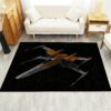 X-Wing Starfighter rug in front of a sofa, featuring the detailed Star Wars spacecraft design
